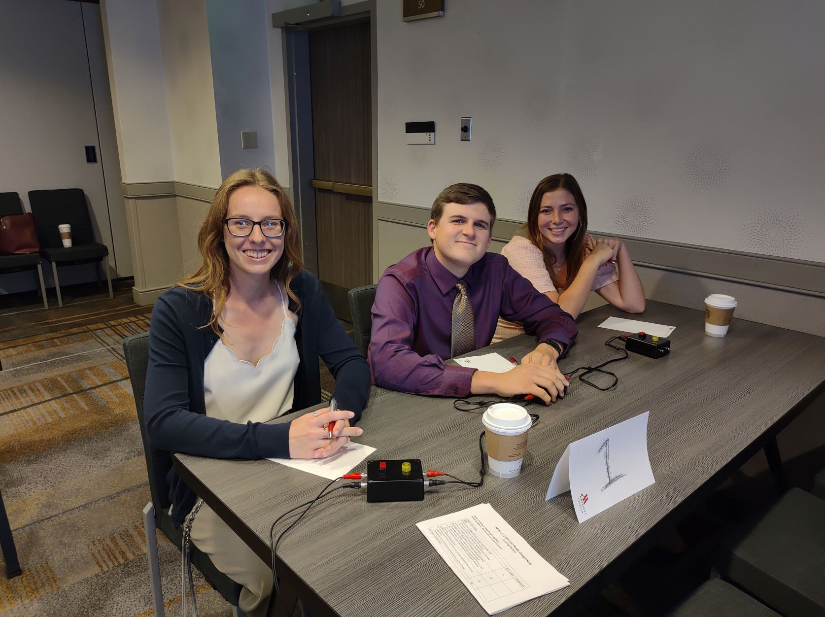 quiz bowl team 2 sits at table before competition