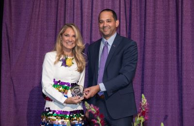 Jamie Glas and Dean Llorens on stage holding award