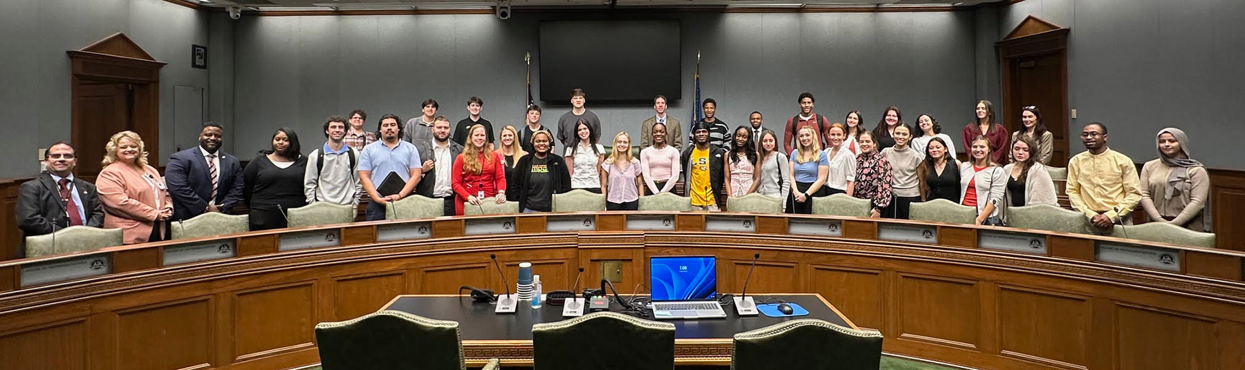 A group photo of about 25 LSU undergraduates in business attire during a visit to the Louisiana Capitol.