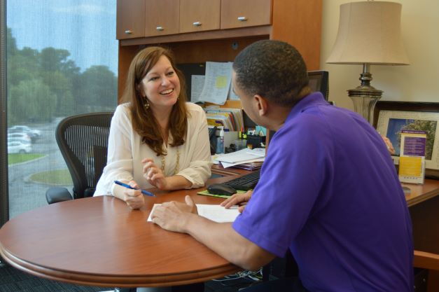 Counselor speaks with studnet in her office.