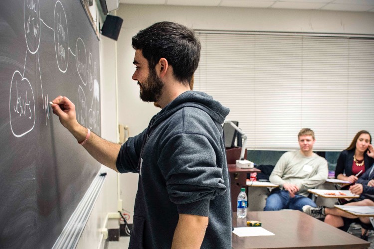 SI leader writing on chalkboard