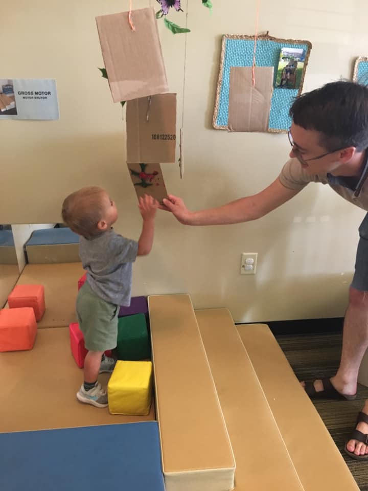 A child and mother interacting with art.