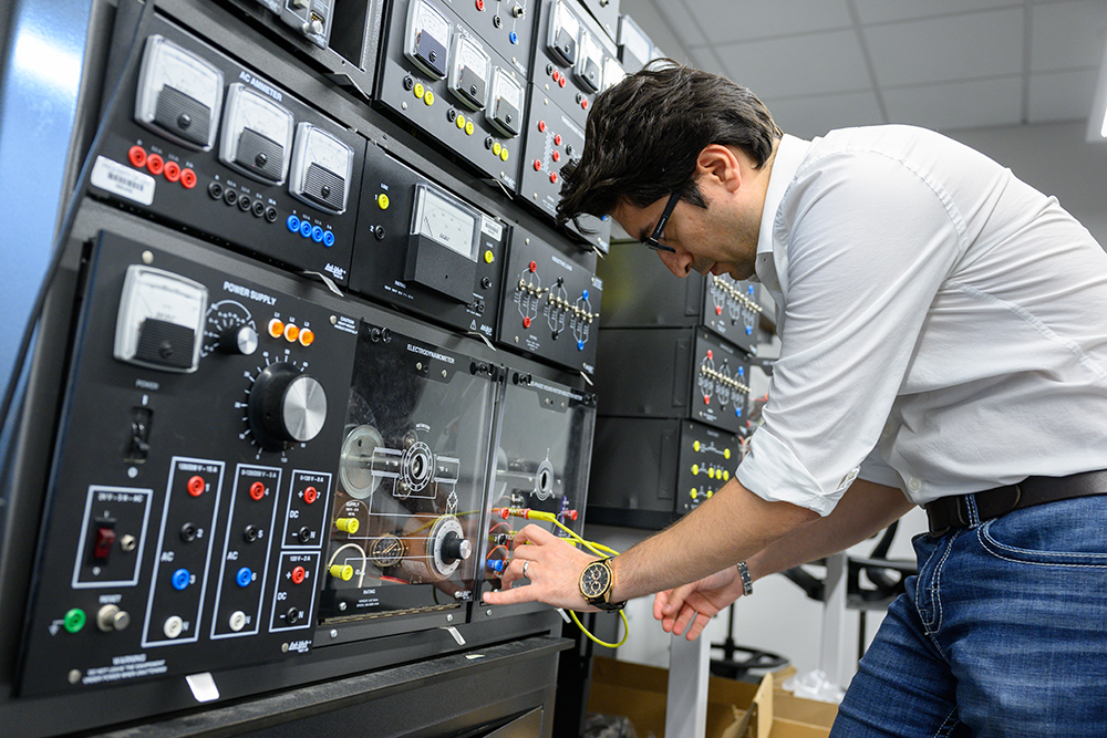 Student plugging in cables to console