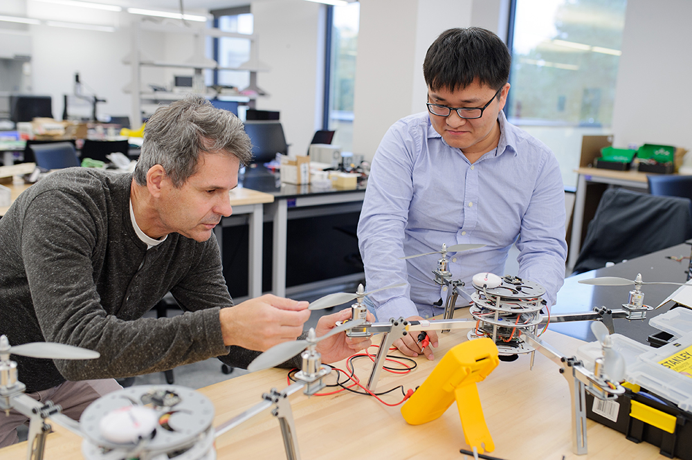 Teacher and student working on quad copter