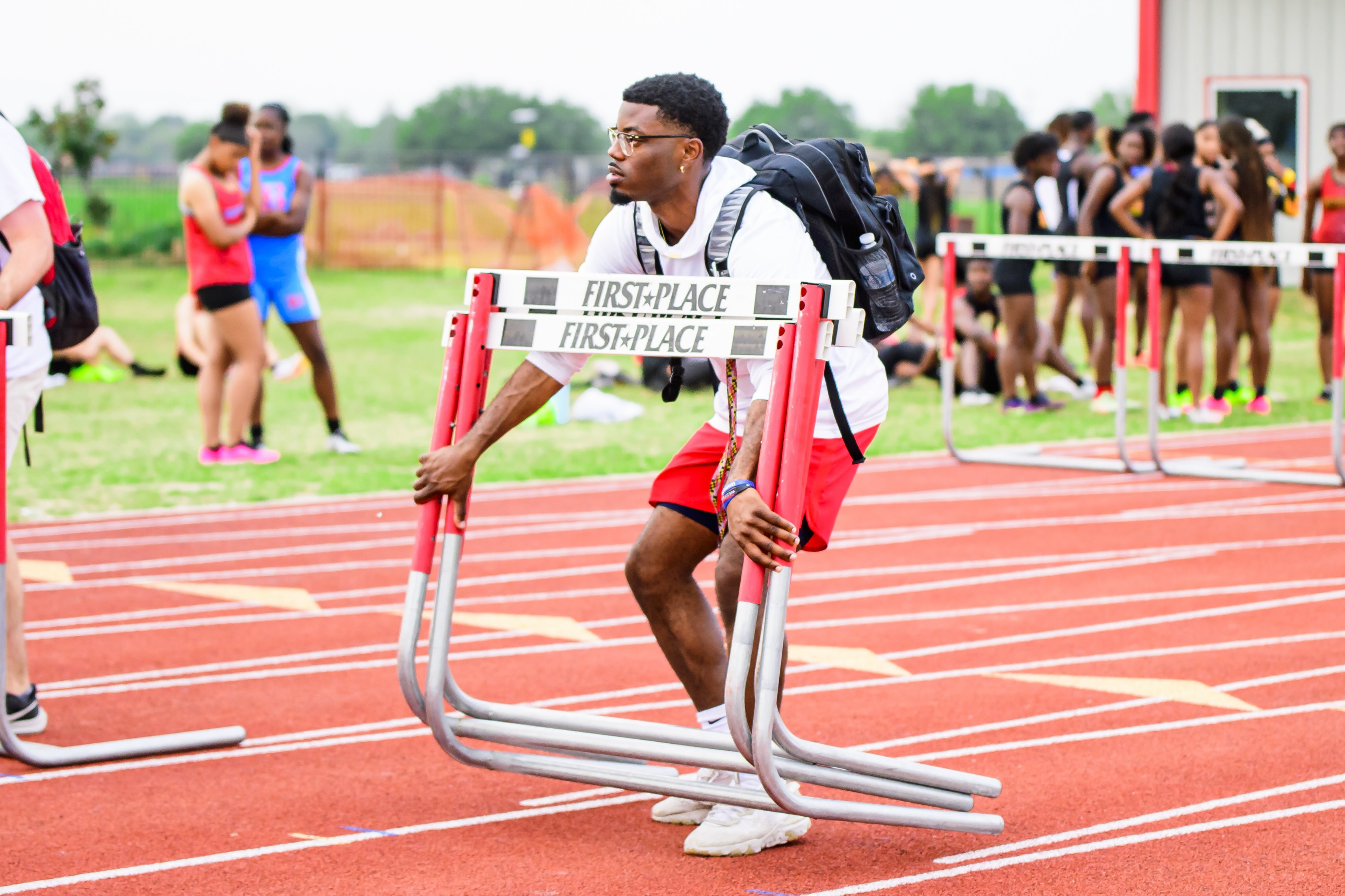  Anthony prepares for the next event at a high school track meet.