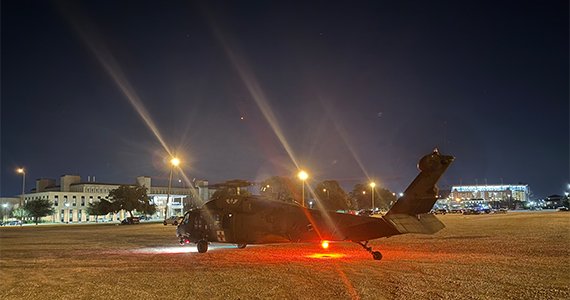 Black Hawk helicopter landing in a parking lot